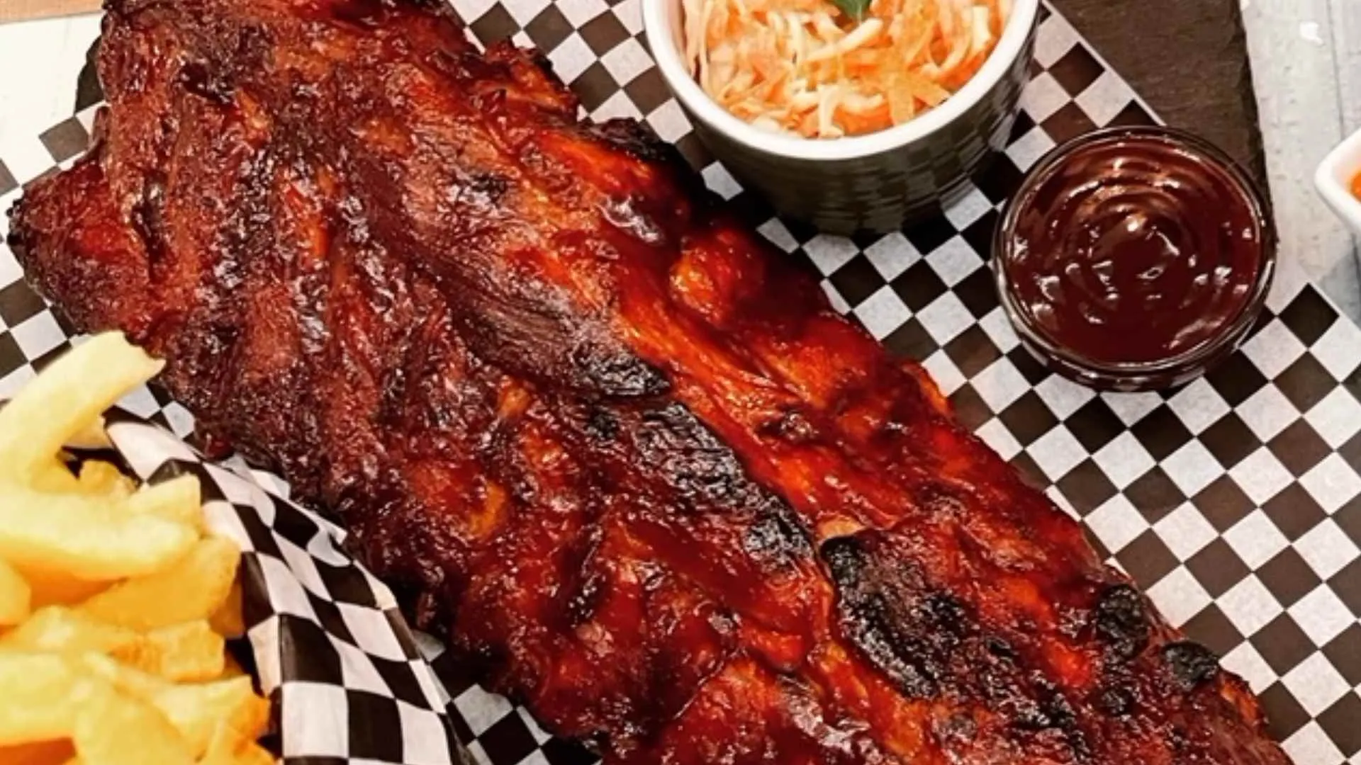 BBQ ribs with fries, coleslaw and barbecue sauce